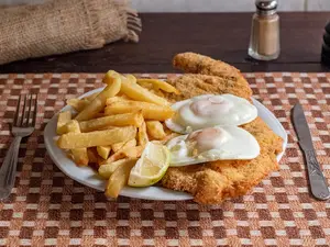 Milanesa a caballo guarnición