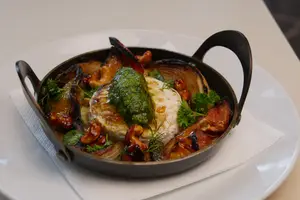 Petit brie al horno con vegetales y pesto