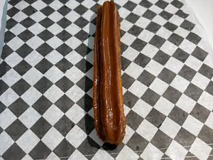 Churro bañado con chocolate