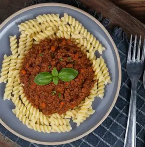 Pasta fusilli con salsa raghu